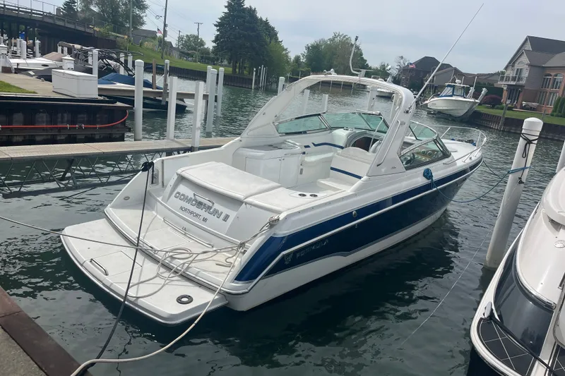 Slide: The Image of 2006 Formula 330 Sun Sport boat docked in a marina, featuring sleek design and spacious seating. - 2