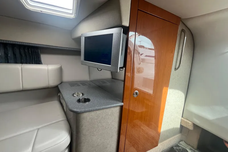 Slide: The Image of Interior of 2006 Formula 330 Sun Sport with TV, seating, and wooden cabinet. - 20