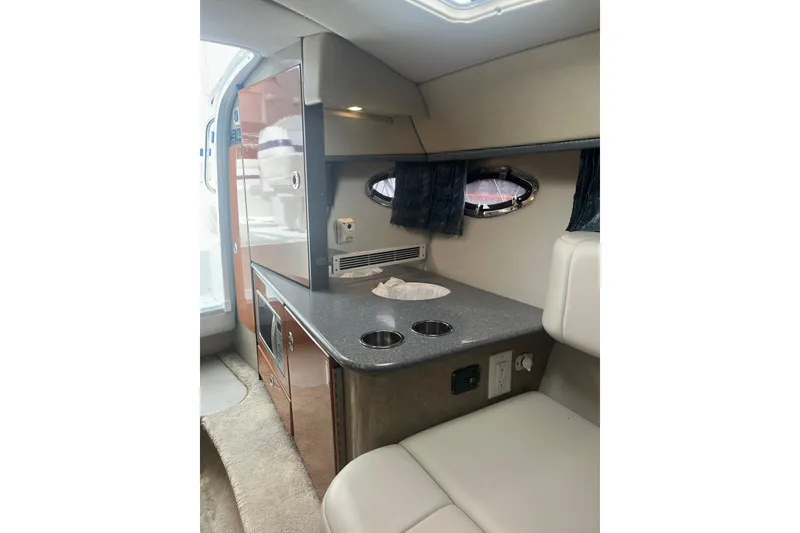 Slide: The Image of Interior of a 2006 Formula 330 Sun Sport boat with kitchenette and seating area. - 24