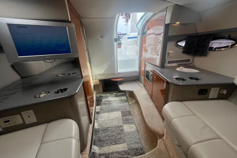 Slide: The Image of Interior of a 2006 Formula 330 Sun Sport boat with seating, TV, and kitchenette. - 25