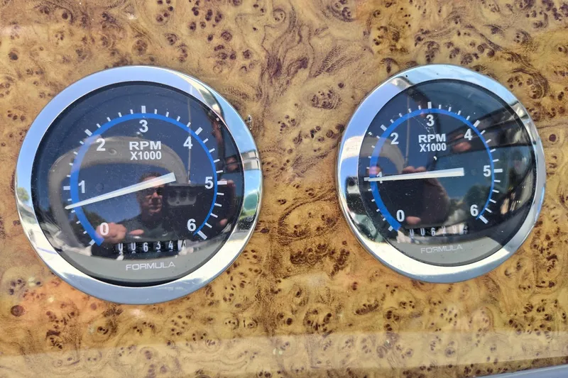 Slide: The Image of Close-up of 2006 Formula 330 Sun Sport RPM gauges on a wood-patterned dashboard. - 26
