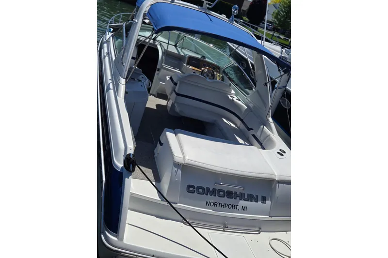 Slide: The Image of 2006 Formula 330 Sun Sport boat with blue canopy, docked in Northport, MI. - 27