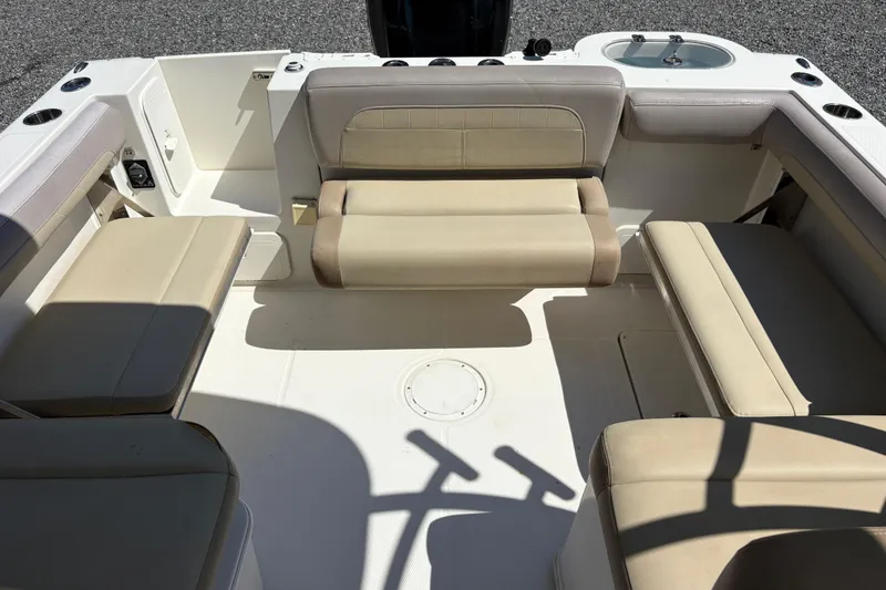 Slide: The Image of 2017 Sailfish 245 DC boat interior with beige seating and spacious layout. - 10