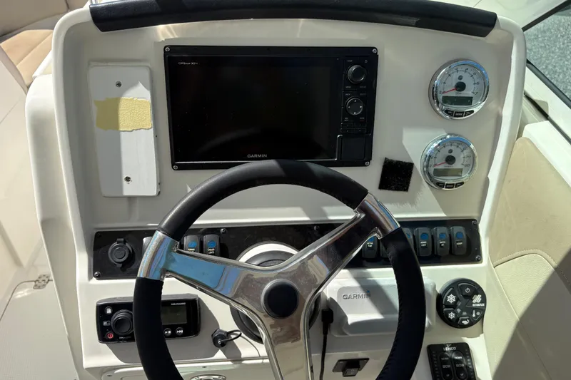 Slide: The Image of Steering console of 2017 Sailfish 245 DC boat with Garmin display and gauges. - 14