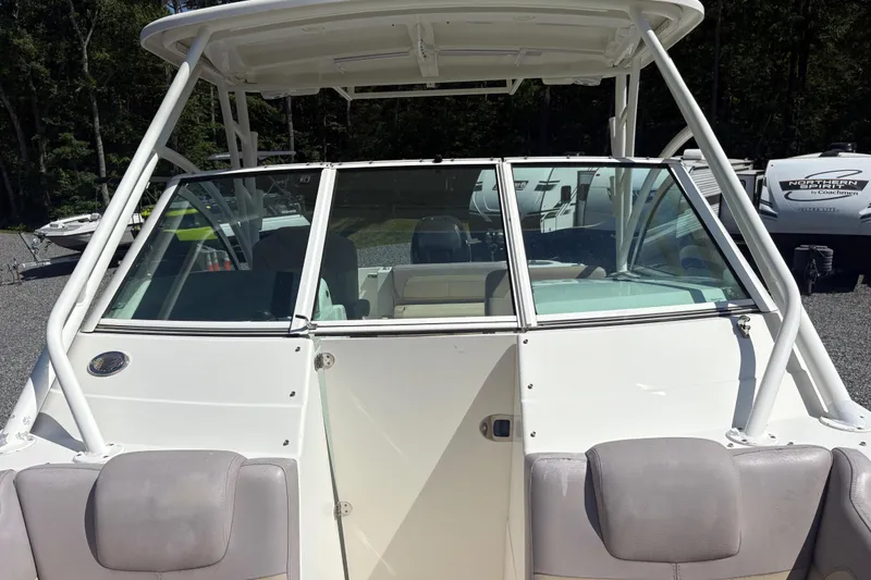 Slide: The Image of 2017 Sailfish 245 DC boat with windshield and seating, parked outdoors. - 20