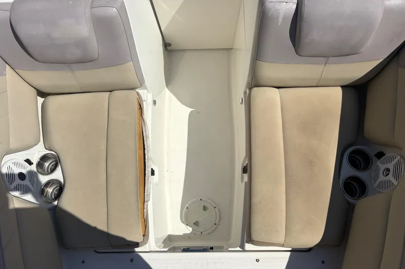 Slide: The Image of 2017 Sailfish 245 DC boat interior with beige seating and cup holders. - 22