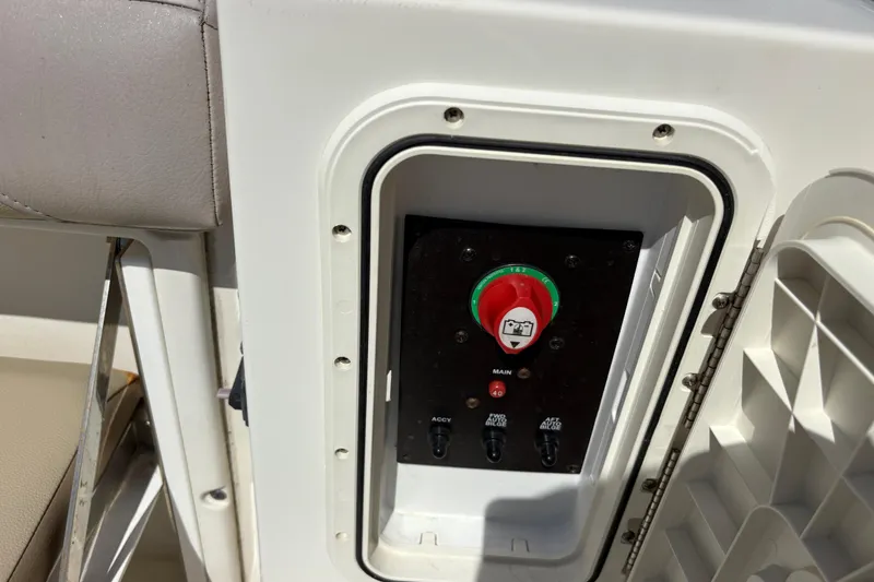 Slide: The Image of Control panel on a 2017 Sailfish 245 DC boat, featuring switches and a red main dial. - 7