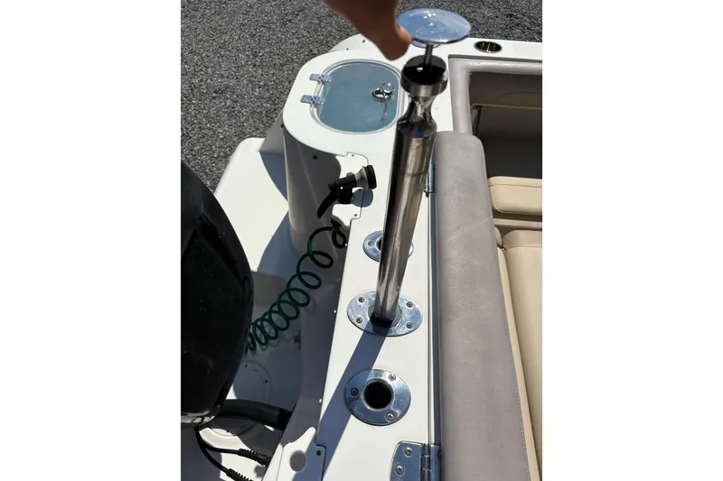 Slide: The Image of 2017 Sailfish 245 DC boat interior with rod holder and seating area. - 9