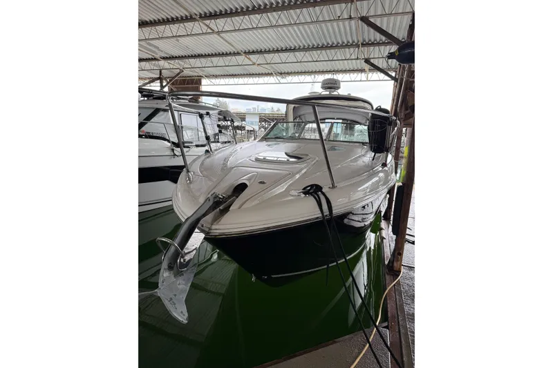 Slide: The Image of 2007 Sea Ray 290 Sundancer boat docked in a covered marina. - 0