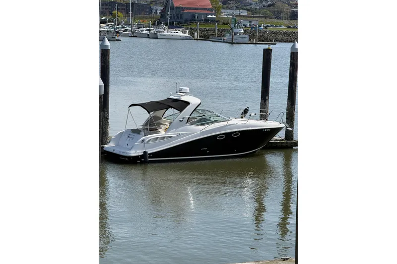 The Image of 2007 Sea Ray 290 Sundancer docked in a marina, calm water, sunny day. - 1