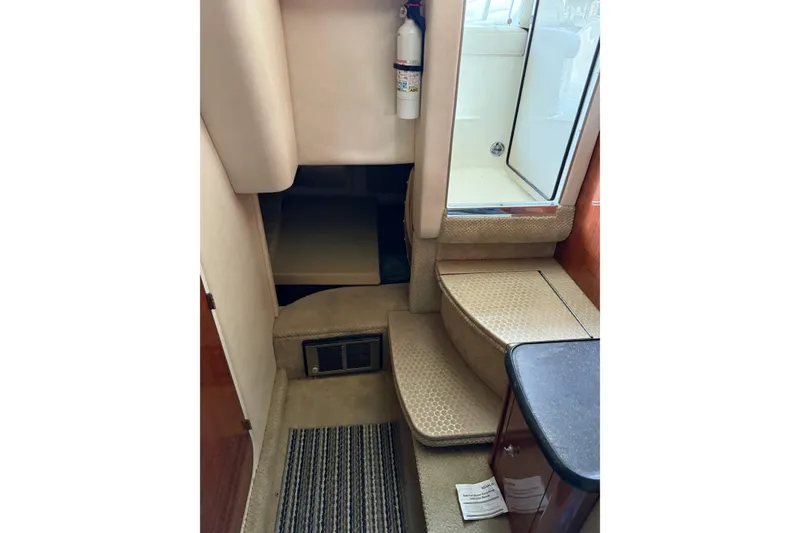 Slide: The Image of Interior of 2007 Sea Ray 290 Sundancer boat with steps and fire extinguisher. - 11