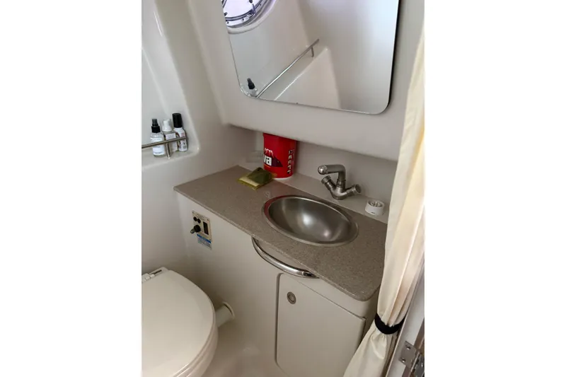 Slide: The Image of 2007 Sea Ray 290 Sundancer bathroom with sink, mirror, and toiletries. - 14