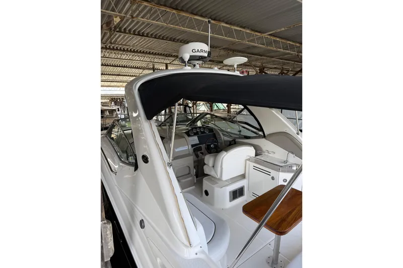 Slide: The Image of 2007 Sea Ray 290 Sundancer boat interior with helm, seating, and Garmin radar. - 2