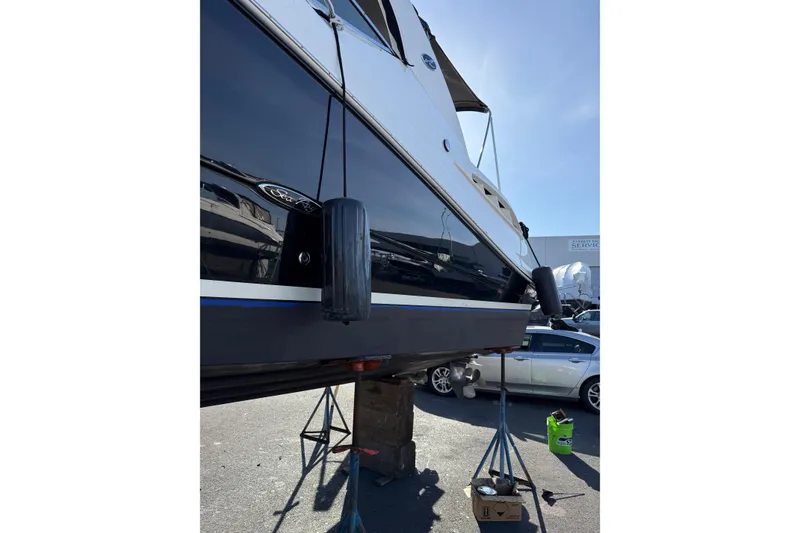 Slide: The Image of 2007 Sea Ray 290 Sundancer boat on stands, side view with fenders. - 3