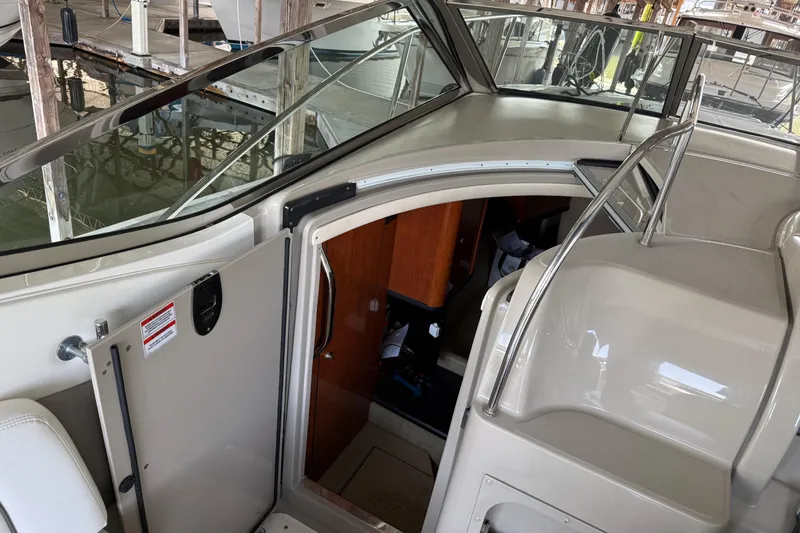 Slide: The Image of 2007 Sea Ray 290 Sundancer cabin entrance with sleek interior design. - 8