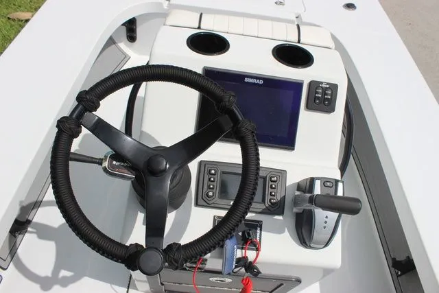 Slide: The Image of 2019 Beavertail Lightning boat console with steering wheel and electronics. - 16