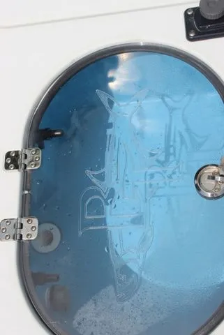 Slide: The Image of Beavertail Lightning 2019 boat deck with oval window and hinges. - 23