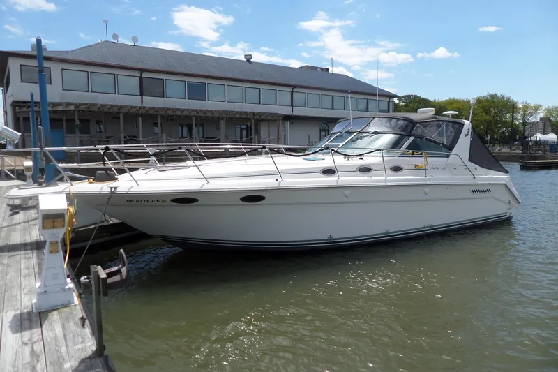 Slide: The Image of 1994 Sea Ray 370 Express Cruiser docked at marina under clear blue sky. - 0