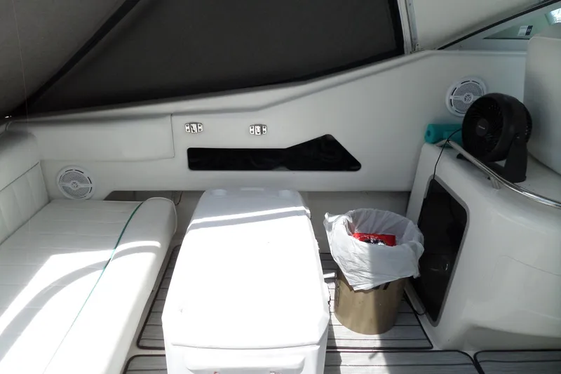 Slide: The Image of Interior of a 1994 Sea Ray 370 Express Cruiser with seating, cooler, and fan. - 10