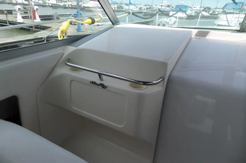 Slide: The Image of Interior view of a 1994 Sea Ray 370 Express Cruiser at a marina. - 12