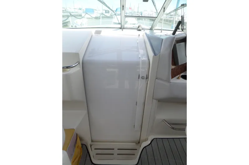 Slide: The Image of 1994 Sea Ray 370 Express Cruiser helm area with white console and seating. - 13
