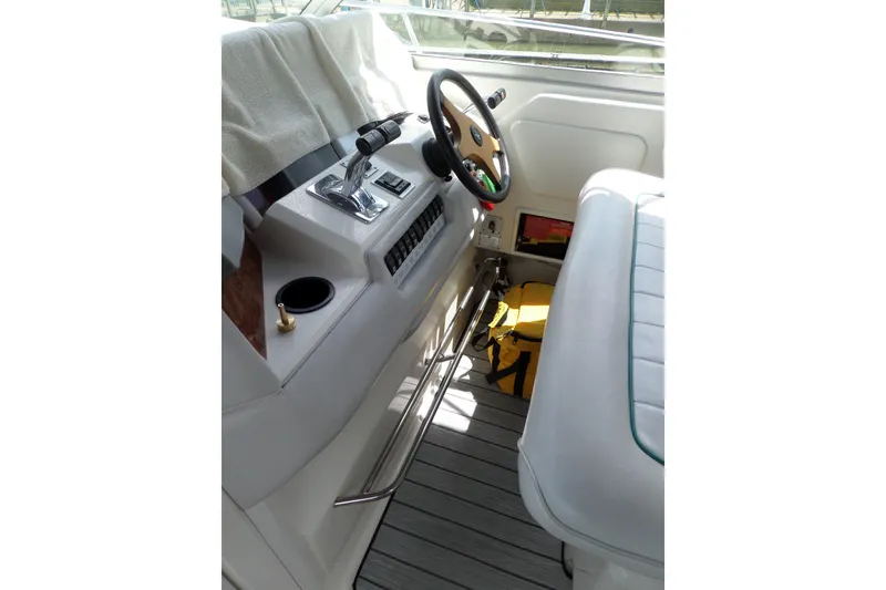 Slide: The Image of Interior helm of 1994 Sea Ray 370 Express Cruiser with steering wheel and controls. - 16