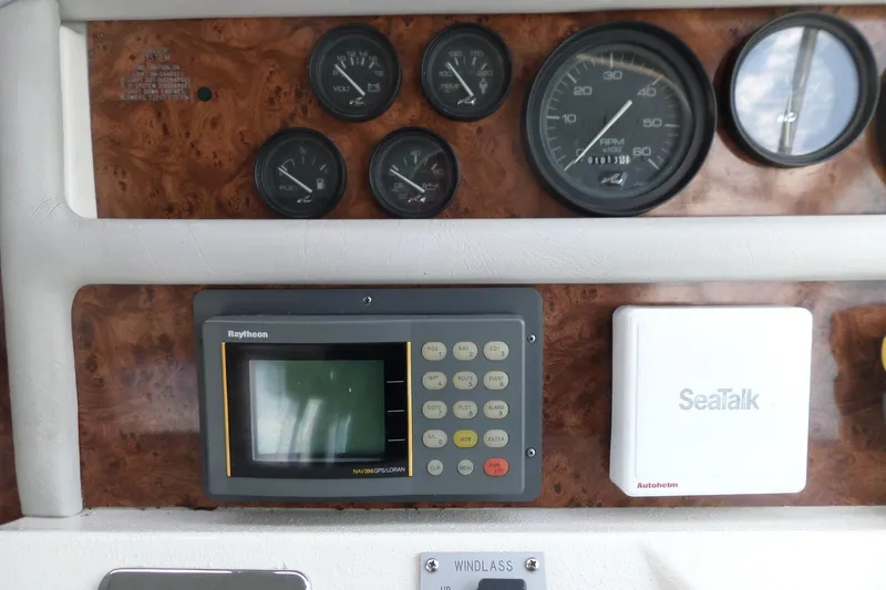 Slide: The Image of 1994 Sea Ray 370 Express Cruiser dashboard with gauges and navigation equipment. - 18