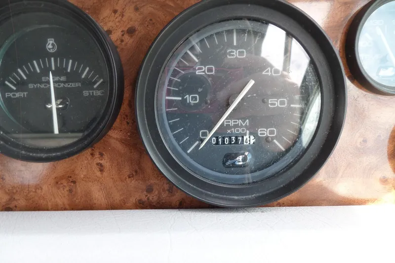 Slide: The Image of Close-up of 1994 Sea Ray 370 Express Cruiser dashboard gauges, showing RPM and engine synchronizer. - 20