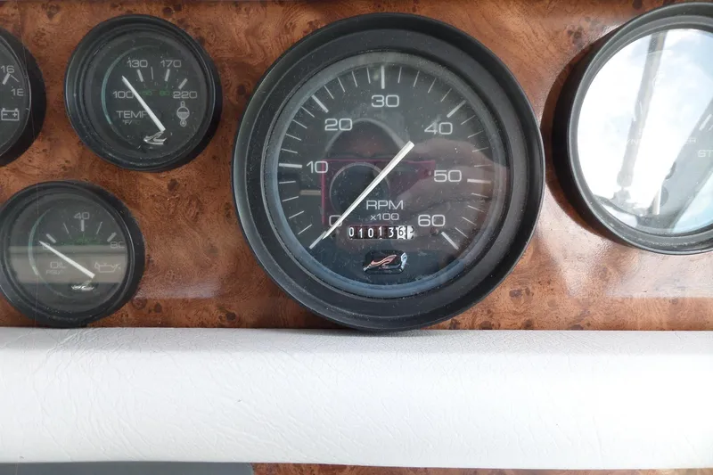Slide: The Image of 1994 Sea Ray 370 Express Cruiser dashboard with RPM and temperature gauges. - 21