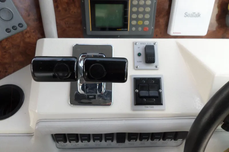 Slide: The Image of Control panel of a 1994 Sea Ray 370 Express Cruiser with throttle and navigation instruments. - 24