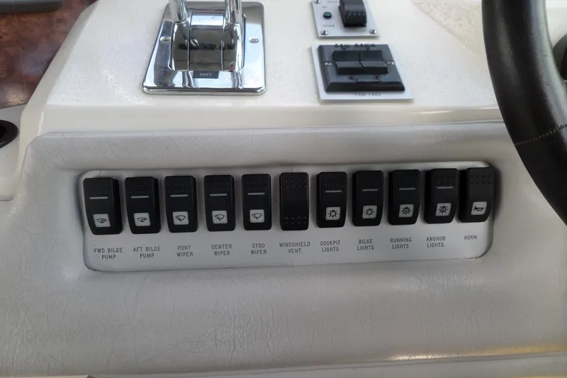 Slide: The Image of Control panel of a 1994 Sea Ray 370 Express Cruiser with labeled switches. - 25