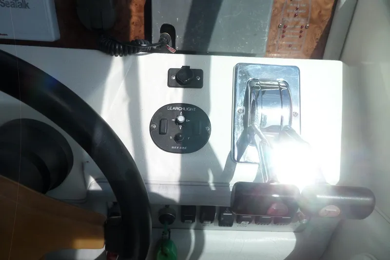 Slide: The Image of 1994 Sea Ray 370 Express Cruiser helm controls with steering wheel and throttle levers. - 27