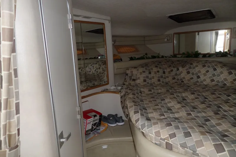 Slide: The Image of Interior cabin of a 1994 Sea Ray 370 Express Cruiser with patterned bedding. - 29