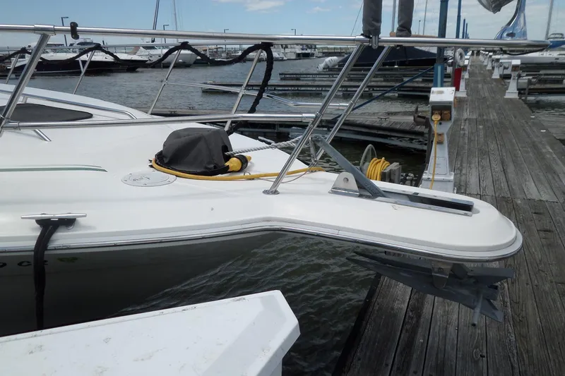 Slide: The Image of 1994 Sea Ray 370 Express Cruiser docked, showcasing bow and anchor at marina. - 3