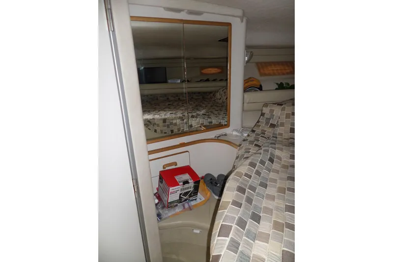 Slide: The Image of Interior cabin of 1994 Sea Ray 370 Express Cruiser with mirror and patterned bedding. - 30