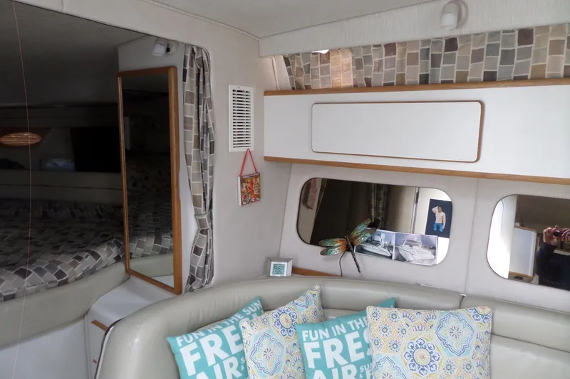 Slide: The Image of Interior of 1994 Sea Ray 370 Express Cruiser with cozy seating and decorative pillows. - 31