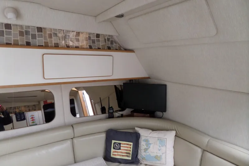 Slide: The Image of Interior of 1994 Sea Ray 370 Express Cruiser with cozy seating and decor. - 33