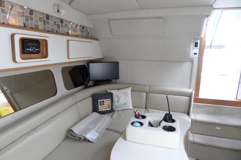 Slide: The Image of Interior of 1994 Sea Ray 370 Express Cruiser with seating and navigation equipment. - 34