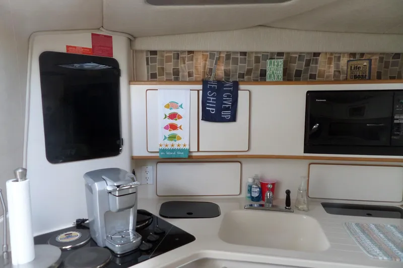 Slide: The Image of Interior of 1994 Sea Ray 370 Express Cruiser kitchen with appliances and decor. - 39