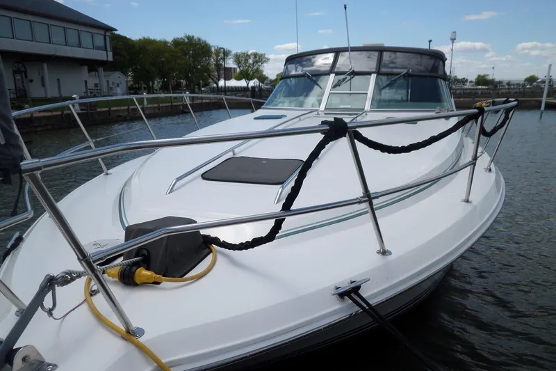 Slide: The Image of 1994 Sea Ray 370 Express Cruiser docked at marina, showcasing sleek design and spacious deck. - 4