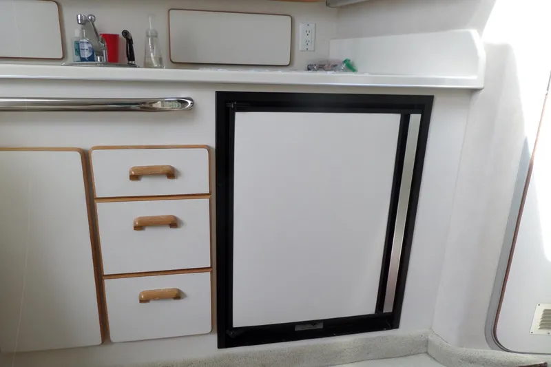 Slide: The Image of 1994 Sea Ray 370 Express Cruiser interior kitchen with sink, drawers, and refrigerator. - 41