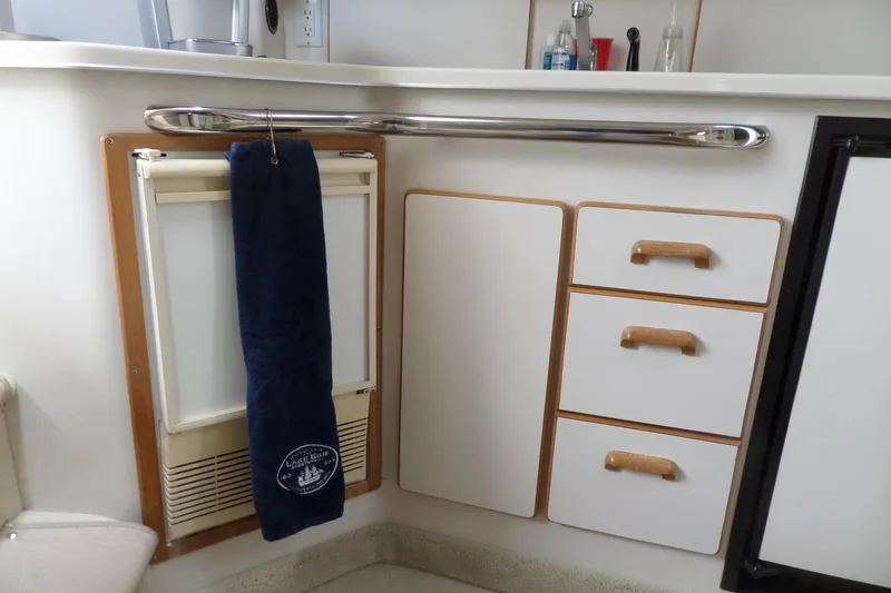 Slide: The Image of Interior of 1994 Sea Ray 370 Express Cruiser with towel and cabinetry. - 42