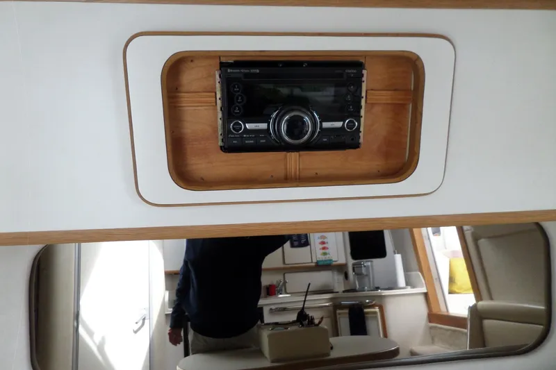 Slide: The Image of Interior of 1994 Sea Ray 370 Express Cruiser with stereo system and cabin view. - 44