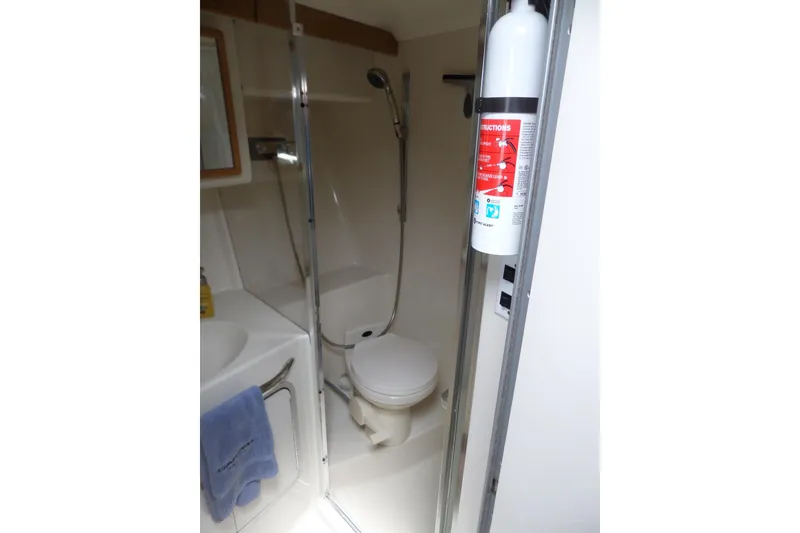 Slide: The Image of Bathroom interior of 1994 Sea Ray 370 Express Cruiser with shower and fire extinguisher. - 45