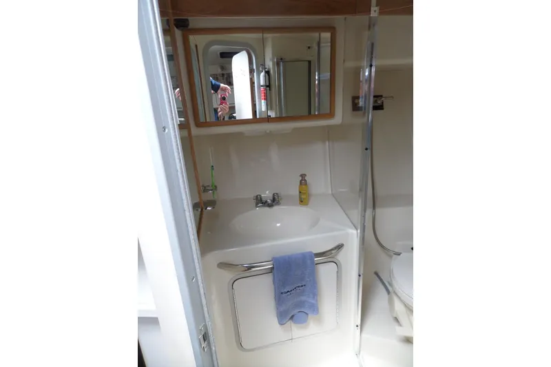 Slide: The Image of Bathroom interior of 1994 Sea Ray 370 Express Cruiser with sink and mirror. - 46