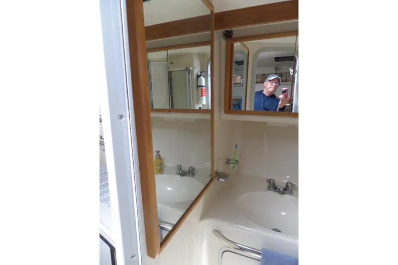 Slide: The Image of Bathroom interior of 1994 Sea Ray 370 Express Cruiser with mirror and sink. - 47