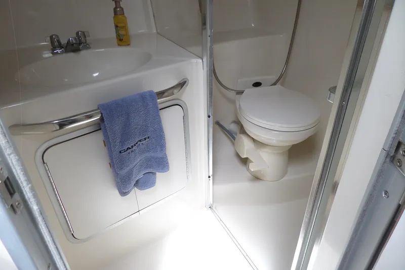 Slide: The Image of Bathroom interior of 1994 Sea Ray 370 Express Cruiser with sink and toilet. - 48