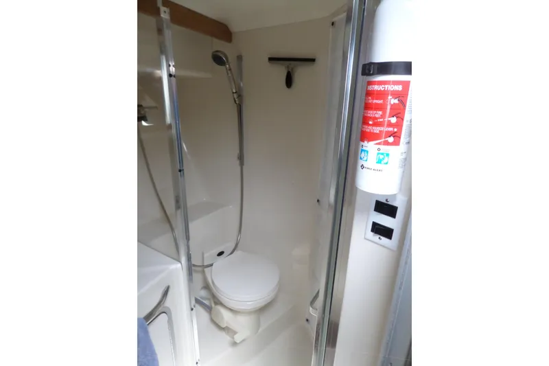 Slide: The Image of Bathroom interior of 1994 Sea Ray 370 Express Cruiser with shower and fire extinguisher. - 49