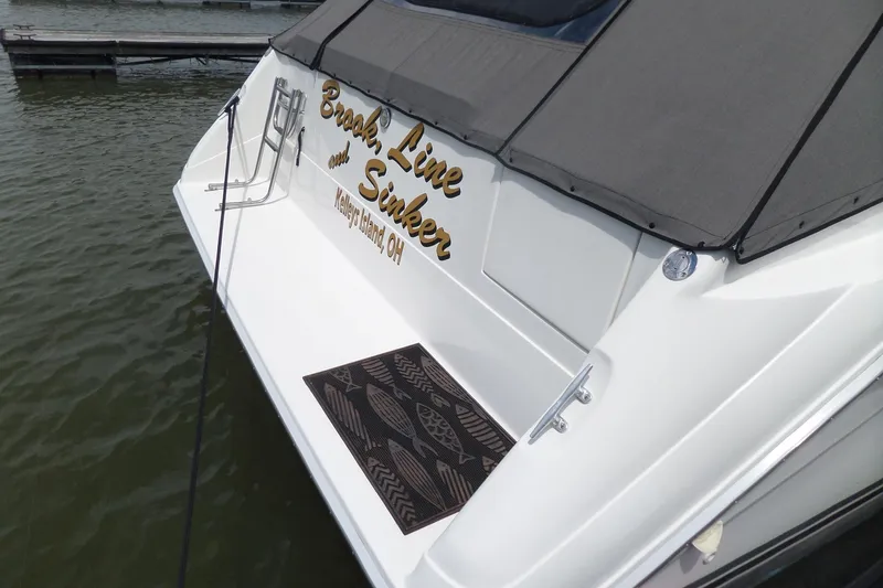 Slide: The Image of 1994 Sea Ray 370 Express Cruiser docked, featuring custom name and mat, Kelleys Island, OH. - 5