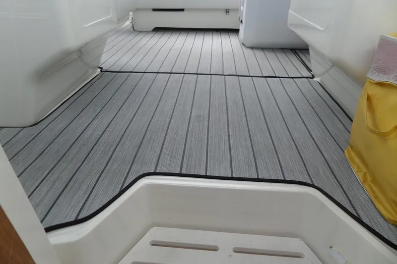 Slide: The Image of 1994 Sea Ray 370 Express Cruiser interior with striped flooring and yellow storage bag. - 50